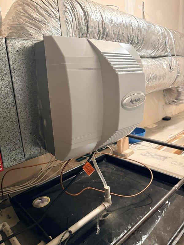 Diagnosed leaking Aprilaire humidifier installed on residential HVAC system that was causing operational issues with the furnace. Documented the installation configuration, including the ceiling-mounted air handler and associated ductwork. Customer had temporarily disabled the humidifier prior to service call.