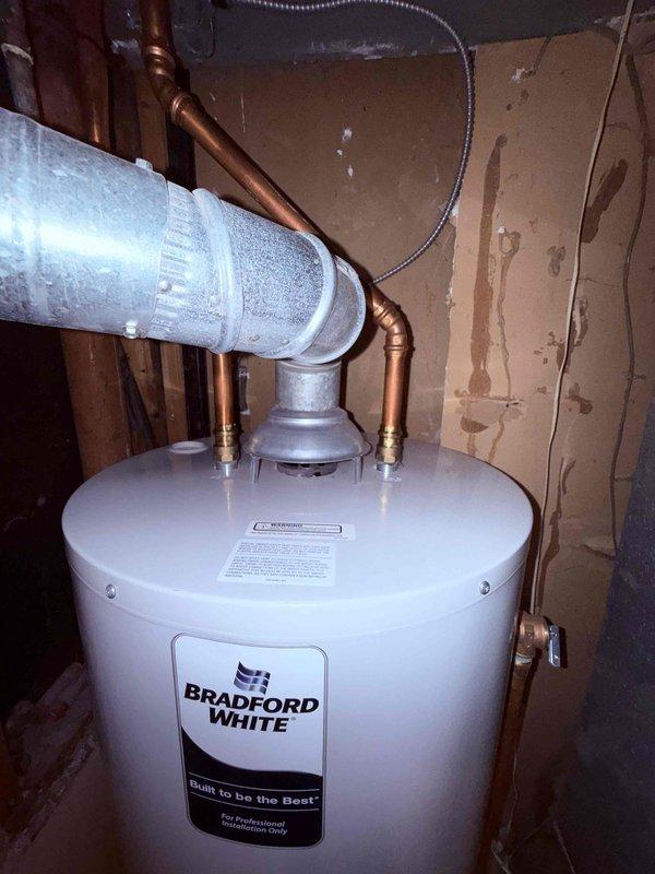 Performed comprehensive Clean and Check service on a dual system setup including furnace, water heater, and humidifier per customer's Comfort Plan agreement. Inspected furnace blower assembly, electrical connections, and control components, ensuring all wiring was secure and properly connected. Examined Bradford White water heater installation, verifying proper ventilation duct connection and inspecting copper piping and brass fittings for leaks or signs of wear.