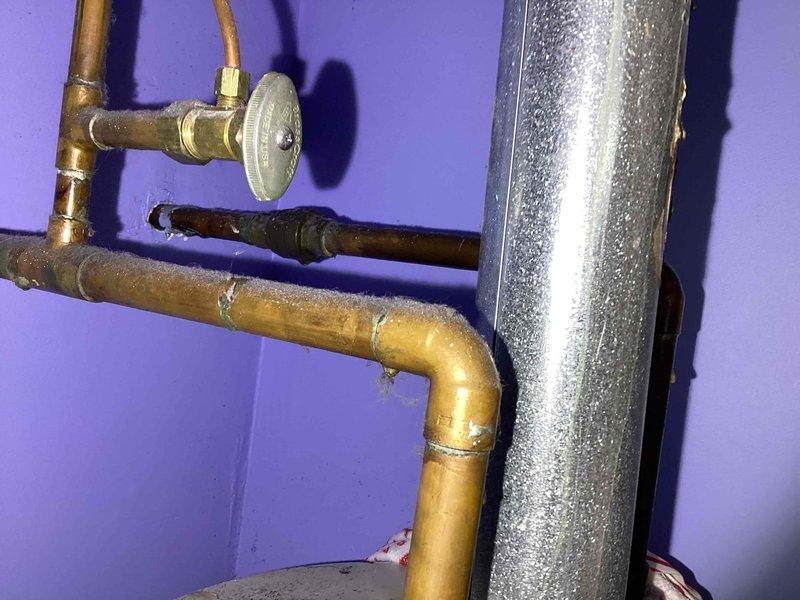 Responded to service call for 20-year-old water heater exhibiting both gas and water leaks. Conducted thorough assessment of the aging unit, documenting visible tank deterioration and compromised gas connections. Recommended immediate replacement due to safety concerns and extensive corrosion observed on copper supply lines and tank body.