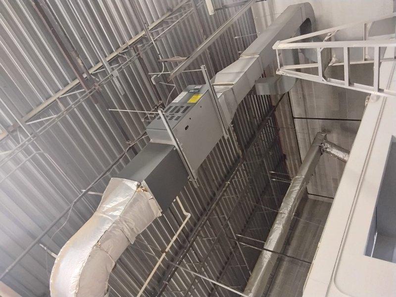 Performed scheduled maintenance on commercial HVAC system (AC CNC unit) including inspection of wall-mounted control unit and connected insulated ductwork. Documented equipment specifications from manufacturer label for maintenance records and verified proper installation of components in industrial facility.
