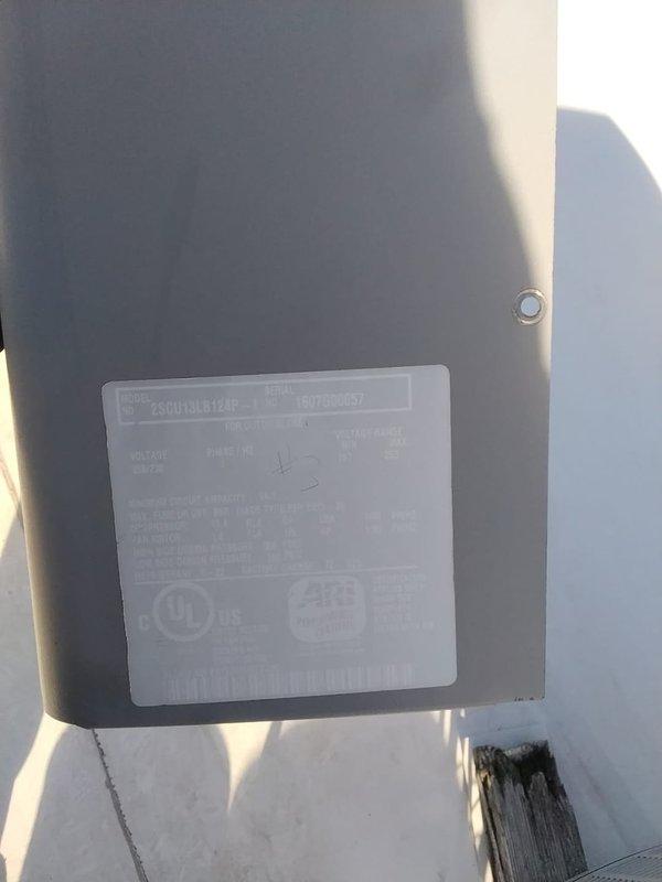 Performed scheduled maintenance on commercial HVAC system (AC CNC unit) including inspection of wall-mounted control unit and connected insulated ductwork. Documented equipment specifications from manufacturer label for maintenance records and verified proper installation of components in industrial facility.