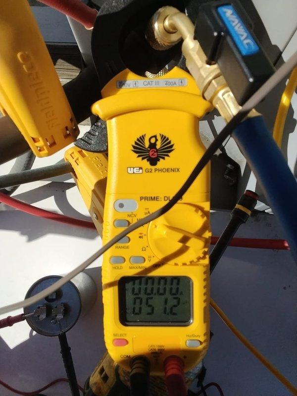 Performed routine maintenance check on Carrier commercial HVAC system (unit 106). Inspected ceiling-mounted furnace installation and associated ductwork for proper condition. Conducted electrical diagnostics using UEi G2 PHOENIX clamp meter to verify system parameters, confirming proper voltage readings and electrical performance.