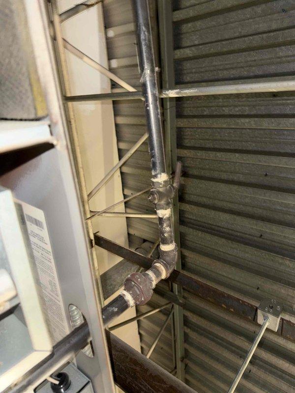 Performed routine maintenance on commercial AC unit (201) under service agreement. Inspected control board circuitry and wire connections, noting all connections secure with no signs of overheating. Examined pipe junctions and seals in the mechanical assembly, confirming proper sealing compound at connection points with no evidence of leaks.