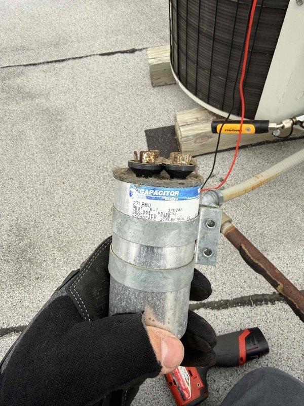 Diagnosed failed capacitor in rooftop commercial HVAC unit exhibiting signs of corrosion at terminals. Accessed electrical compartment, disconnected wiring, removed deteriorated capacitor, and installed new replacement component with proper specifications. Verified proper operation of unit after repair and secured all access panels.