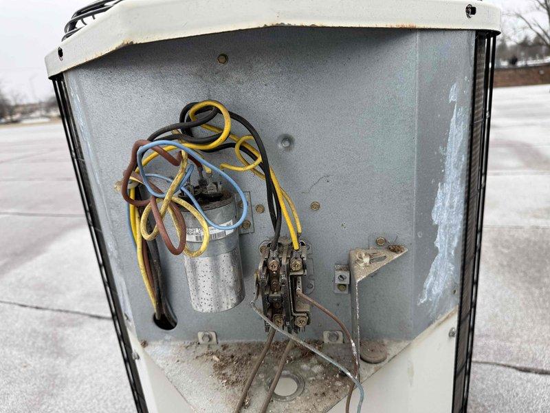 Diagnosed failed capacitor in rooftop commercial HVAC unit exhibiting signs of corrosion at terminals. Accessed electrical compartment, disconnected wiring, removed deteriorated capacitor, and installed new replacement component with proper specifications. Verified proper operation of unit after repair and secured all access panels.