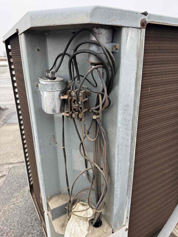Replaced severely corroded capacitor on commercial HVAC unit with new JARD capacitor after inspection revealed significant deterioration and rust on the original component. System access panel was removed to facilitate repair work, with all electrical connections properly secured following manufacturer specifications.