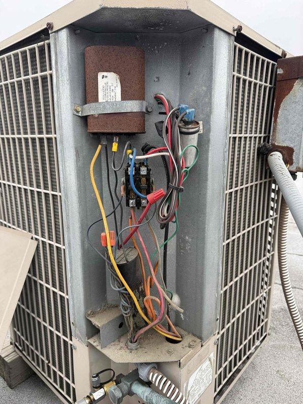 Performed spring commercial maintenance service on rooftop York HVAC unit. Accessed electrical compartment for inspection of wiring, contactors, and capacitor. Completed required maintenance checklist and documented equipment specifications including filter information for system update.