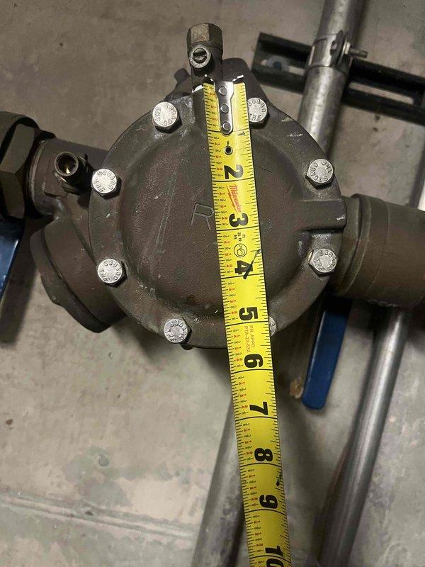 Responded to service call for low water pressure and no hot water. Inspected tanked water heater system in mechanical room, documenting the condition of the unit and associated plumbing connections. Identified issue with circular flange valve, measured component dimensions, and performed necessary repairs to restore proper hot water flow and system pressure.