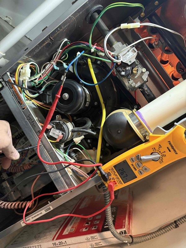 Performed diagnostic testing on furnace with no heat complaint. Conducted voltage measurements at gas valve using multimeter, recording 20.1V reading. Inspected electrical components, wiring connections, and blower assembly to identify cause of heating failure.