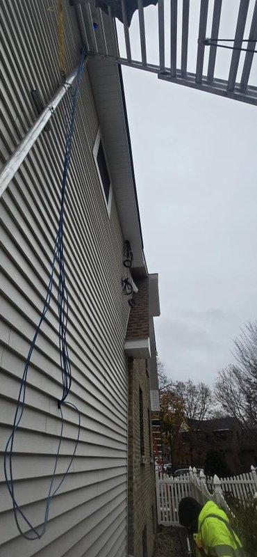 Conducted diagnostic check on residential property to assess remaining work requirements. Documented exterior condition where multiple cables are currently unsecured along vinyl siding. Verified scope of work needed to properly secure and organize wiring on exterior wall for completion of installation.