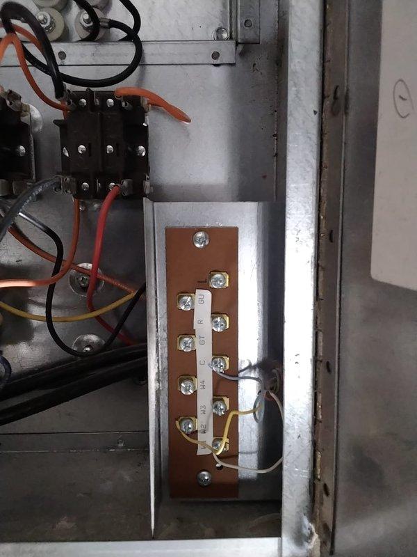 Completed de-watering procedure on water source heat pump and associated heat kit. Inspected electrical control panel connections, verifying proper termination of wiring at terminal board and relay/contactor. Confirmed functionality of digital thermostat interface and control system.