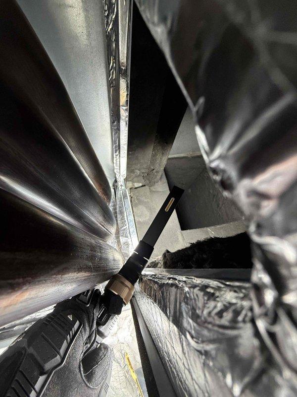 Investigated reported burning smell in HVAC system following previous replacement of RTU and blower motor. Conducted thorough inspection of ductwork and ventilation components, confirming source of odor and verifying proper installation of ceiling-mounted air vent/return grille.