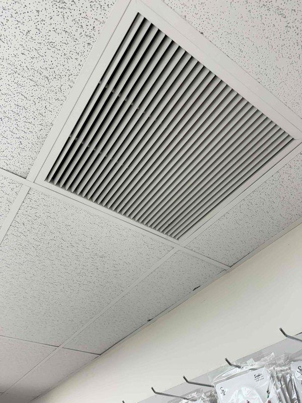 Investigated reported burning smell in HVAC system following previous replacement of RTU and blower motor. Conducted thorough inspection of ductwork and ventilation components, confirming source of odor and verifying proper installation of ceiling-mounted air vent/return grille.