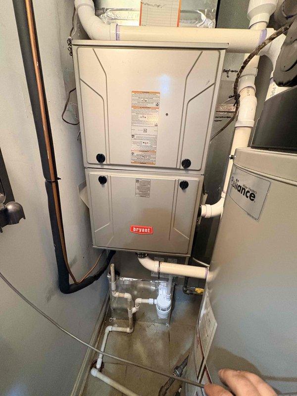Successfully installed an Axiom NC-1W condensate neutralizer kit on the Bryant furnace system to properly treat acidic condensate before discharge. The neutralizer was connected to the existing PVC condensate drain line with appropriate fittings, ensuring compliance with local codes for condensate disposal from high-efficiency equipment.