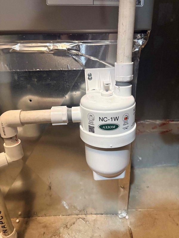 Successfully installed an Axiom NC-1W condensate neutralizer kit on the Bryant furnace system to properly treat acidic condensate before discharge. The neutralizer was connected to the existing PVC condensate drain line with appropriate fittings, ensuring compliance with local codes for condensate disposal from high-efficiency equipment.