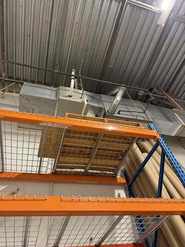 Performed indoor evaporator coil cleaning service in commercial warehouse facility using Nu-Calgon Evap Foam No Rinse foaming coil cleaner. Successfully cleaned HVAC evaporator coils mounted near ceiling above industrial storage racking system. Documented work with photos showing before and after condition of equipment.
