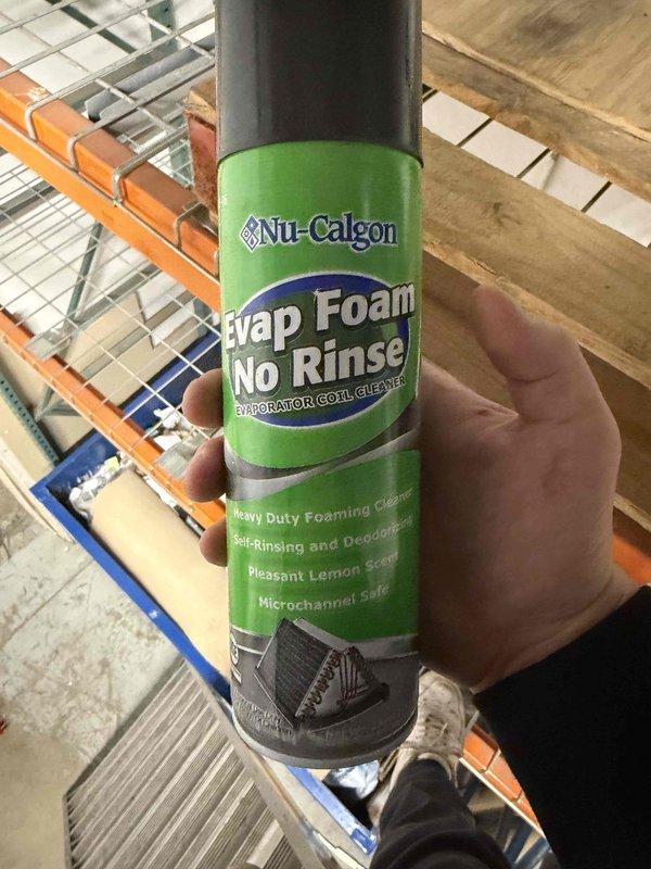 Performed indoor evaporator coil cleaning service in commercial warehouse facility using Nu-Calgon Evap Foam No Rinse foaming coil cleaner. Successfully cleaned HVAC evaporator coils mounted near ceiling above industrial storage racking system. Documented work with photos showing before and after condition of equipment.