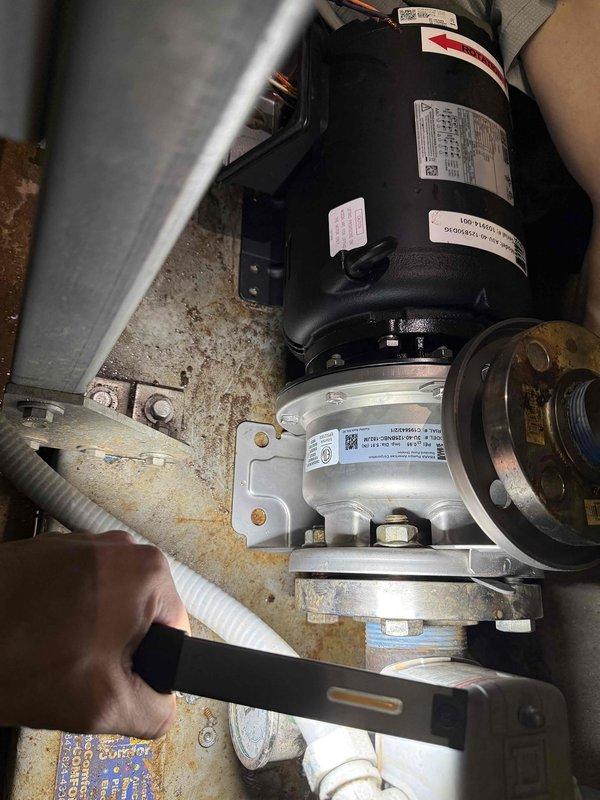 Replaced failed booster pump motor and bearing assembly on commercial HVAC system. System was dismounted from concrete block wall mounting, new components were installed with proper fittings, and system was pressure tested for proper operation before returning to service.