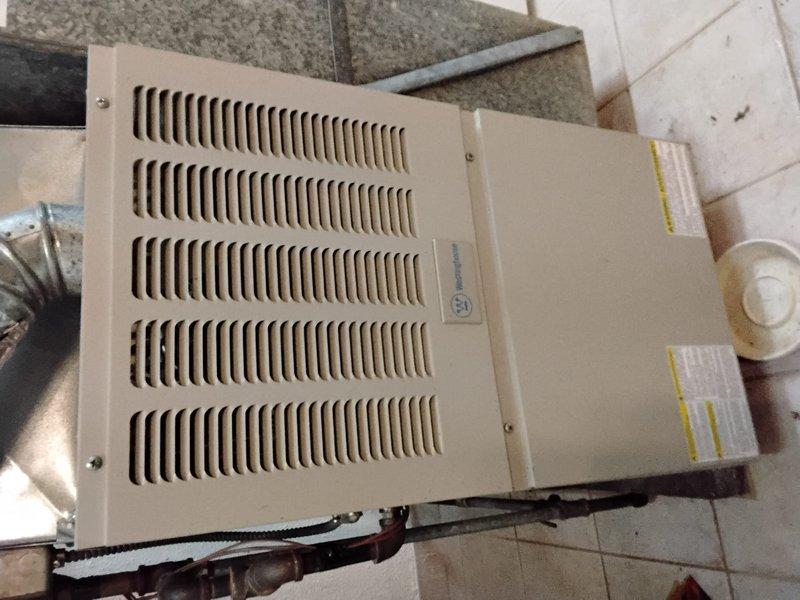 Responded to service call for a leaking furnace that was installed by a previous contractor. Upon inspection of the beige unit with ventilation grille, identified corrosion on electrical connections and deterioration of internal components including mounting brackets and terminal points. Documented condition with photos and provided customer with replacement options.