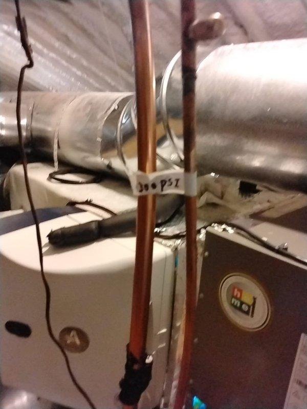 Performed isolation pressure test on the lineset under warranty. System was pressurized to 300 PSI to verify integrity of copper refrigerant lines. Documented installation with photos showing proper configuration of the residential HVAC system including ductwork, connections, and furnace unit.