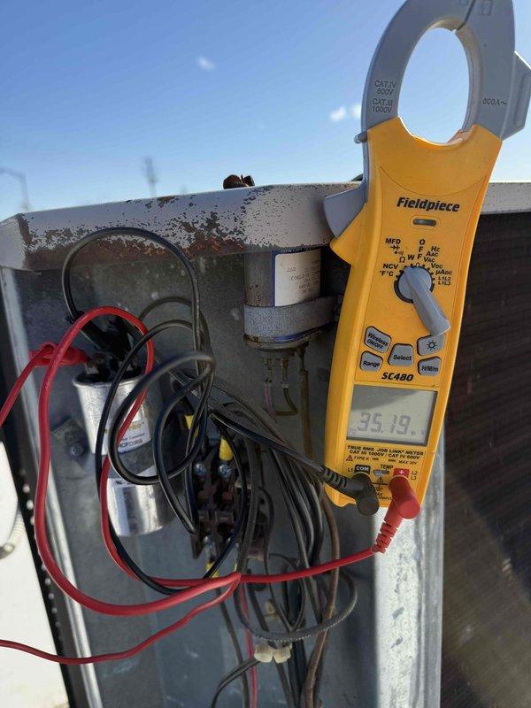 # Service Report

Completed spring commercial preventive maintenance inspection per contract service agreement checklist. Confirmed tenant availability prior to service as per protocol. Performed comprehensive system evaluation of outdoor HVAC unit including electrical diagnostics using clamp meter to verify amperage draw and capacitor performance. Measured compressor amp draw at 35.19 amps and tested capacitor reading of 4.936 MFD to ensure proper operation within manufacturer specifications. Documented current equipment information and filter specifications for maintenance records. Captured photographic documentation of electrical measurements and component conditions. Flagged any necessary updates to filter list for office records. Unit operating within normal parameters at time of service completion.