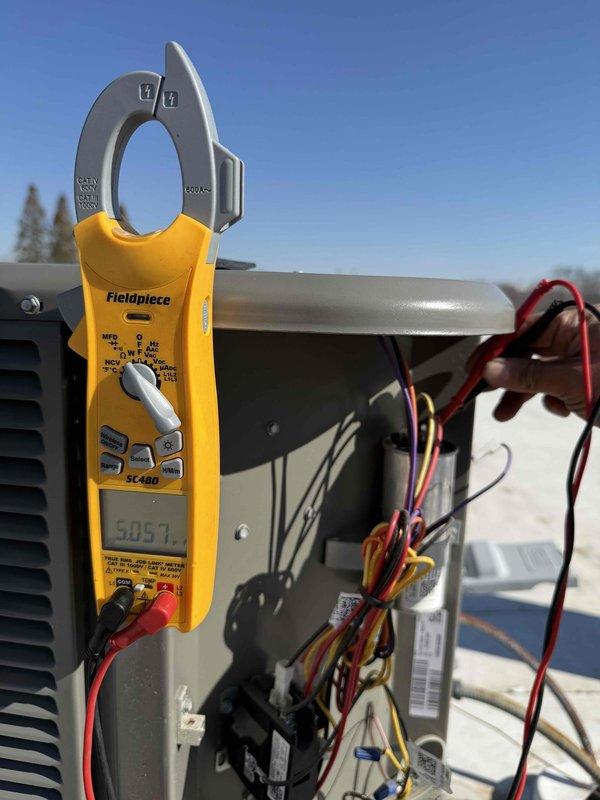 # Service Report

Completed spring preventive maintenance inspection on commercial HVAC system per prepaid service agreement. Coordinated tenant availability prior to site access as required. Performed comprehensive checklist evaluation on Trane XR80 furnace unit located in basement mechanical room, inspecting burner assembly, heat exchanger, blower motor, and all safety controls. Verified proper operation of digital control board and thermostat communication. Inspected ductwork connections, PVC condensate drainage system, and gas supply piping for leaks or deterioration.

Proceeded to outdoor condensing unit and conducted electrical diagnostics using clamp meter, recording voltage and amperage readings at 505.7 on main power supply to verify unit operating within manufacturer specifications. Inspected compressor wiring, capacitor connections, and contactor operation. All electrical components functioning properly with no abnormalities detected. Updated equipment information and filter