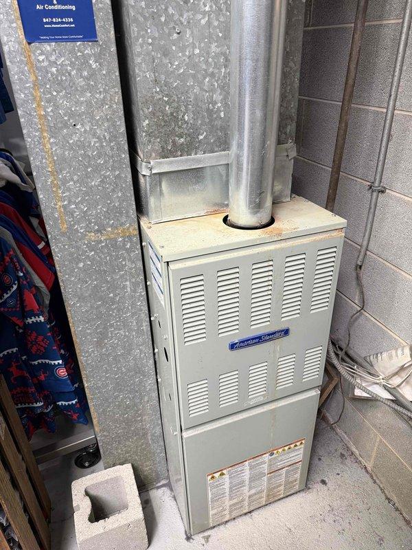 Completed spring preventative maintenance on American Standard residential furnace unit per commercial service agreement checklist. Inspected furnace cabinet, exhaust venting, and ductwork connections for proper operation and safety compliance. Documented current equipment specifications and filter dimensions for service records, noting filter measurements for future replacement scheduling.