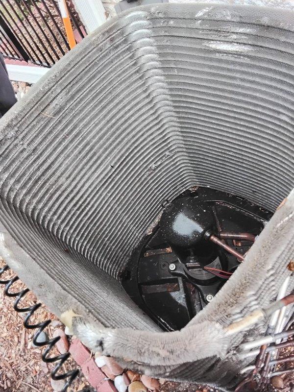Performed comprehensive AC coil cleaning on outdoor condenser unit, removing accumulated dust and debris from the cylindrical condenser coils to restore optimal heat exchange efficiency. Leveled and stabilized the air conditioning unit using pea gravel and vibration pads as needed to ensure proper operation and prevent future mechanical stress. Temporarily relocated decorative gravel from work area during leveling process and restored landscaping materials to original position upon completion.