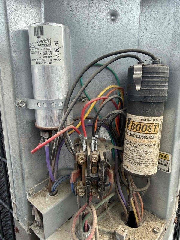 Completed spring preventative maintenance on commercial HVAC unit per contract agreement. Performed comprehensive system inspection including electrical components, capacitors, and contactor assembly. Tested and documented capacitor values using digital multimeter, verified electrical connections, and assessed overall equipment condition. Updated equipment information and filter specifications for maintenance records, noting aged components showing wear and dust accumulation throughout control panel assembly.