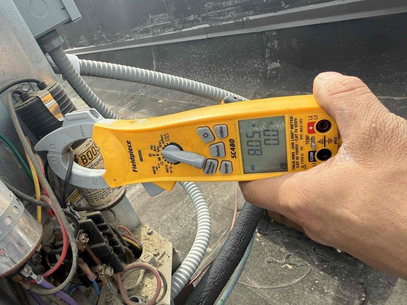 Completed spring preventative maintenance on commercial HVAC unit per contract agreement. Performed comprehensive system inspection including electrical components, capacitors, and contactor assembly. Tested and documented capacitor values using digital multimeter, verified electrical connections, and assessed overall equipment condition. Updated equipment information and filter specifications for maintenance records, noting aged components showing wear and dust accumulation throughout control panel assembly.