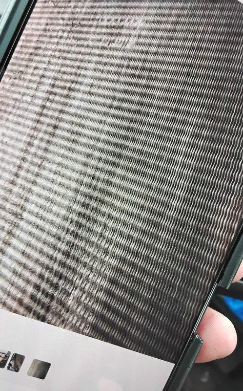 Performed chemical cleaning service on commercial HVAC system, treating both the condensing unit coil and evaporator coil to remove accumulated dirt, dust, and debris that had significantly reduced heat transfer efficiency. Pre-service inspection revealed heavy soiling and discoloration across the evaporator coil fins, particularly concentrated in patches throughout the middle and right sections of the coil assembly. Applied approved chemical cleaning solution to both coils to restore optimal airflow and system performance, ensuring proper operation of the refrigeration cycle and associated copper refrigerant lines.