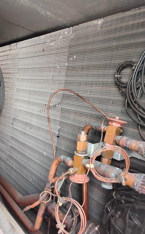 Performed chemical cleaning service on commercial HVAC system, treating both the condensing unit coil and evaporator coil to remove accumulated dirt, dust, and debris that had significantly reduced heat transfer efficiency. Pre-service inspection revealed heavy soiling and discoloration across the evaporator coil fins, particularly concentrated in patches throughout the middle and right sections of the coil assembly. Applied approved chemical cleaning solution to both coils to restore optimal airflow and system performance, ensuring proper operation of the refrigeration cycle and associated copper refrigerant lines.