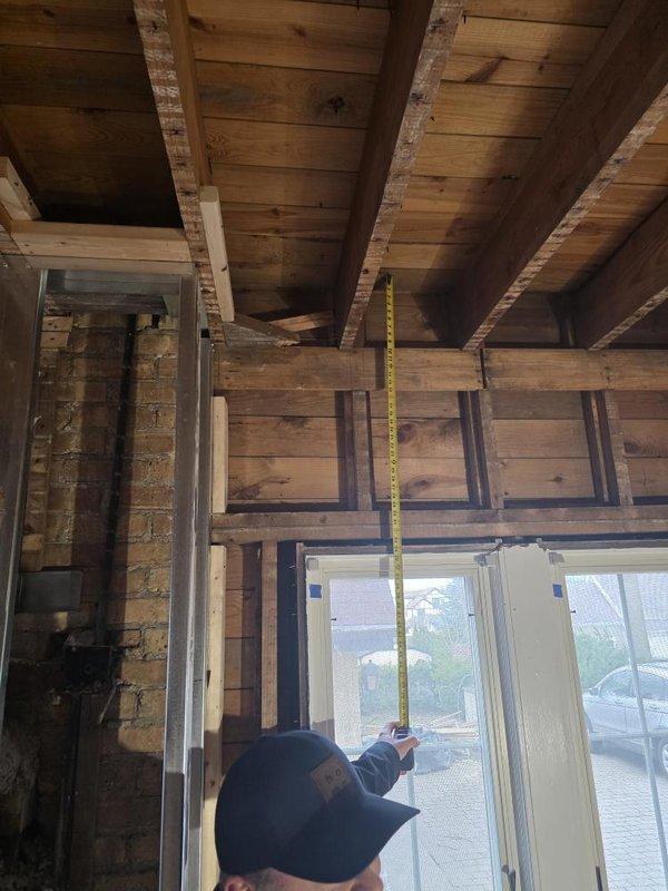 Conducted site assessment of HVAC installation in attic space of structure under renovation. Measured ceiling height clearances and evaluated existing air handler unit with connected flexible ductwork system. Documented equipment configuration, ductwork routing, and structural mounting points to verify proper installation compliance and identify any necessary modifications for optimal system performance.