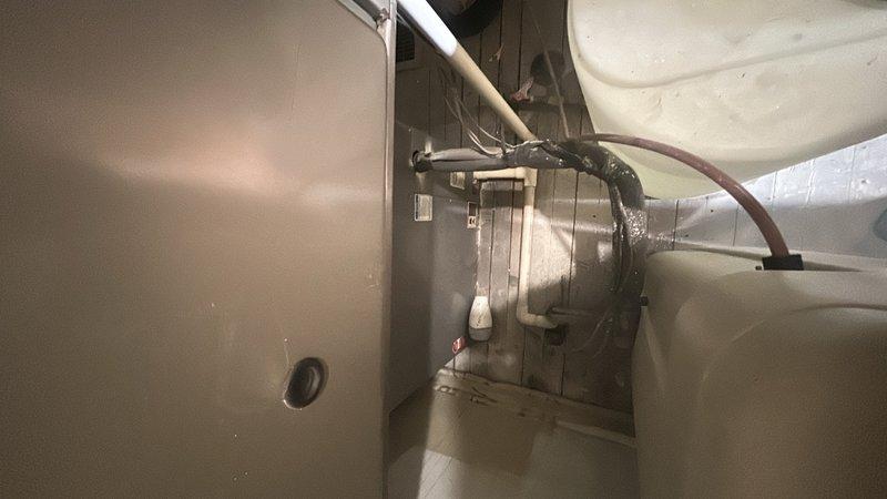 Performed comprehensive furnace inspection and evaluation for new homeowner with unknown equipment age. Assessed air handler unit, blower motor assembly, flexible duct connections, and condensate drainage system. All major HVAC components including the tan-colored air handler cabinet, silver blower assembly, PVC drain lines, and associated ductwork were inspected for operational status and code compliance.