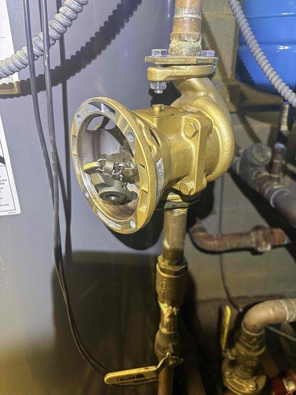 Completed warranty service on domestic hot water circulator pump. Replaced failed bearing assembly on gold-colored DHW circulator due to significant impeller wear and material degradation. Removed defective bearing assembly and returned component for warranty processing per manufacturer requirements.