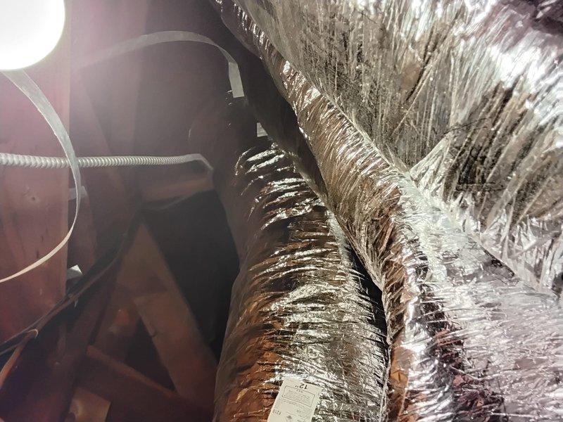 Removed existing supply runs and return ductwork from attic space and replaced with new insulated flexible ductwork. All new supply ducts were properly installed with reflective insulation wrapping to improve system efficiency and temperature control. Connected ductwork to existing air handler unit, ensuring proper sealing and support throughout the attic space to restore optimal airflow distribution to the conditioned areas.