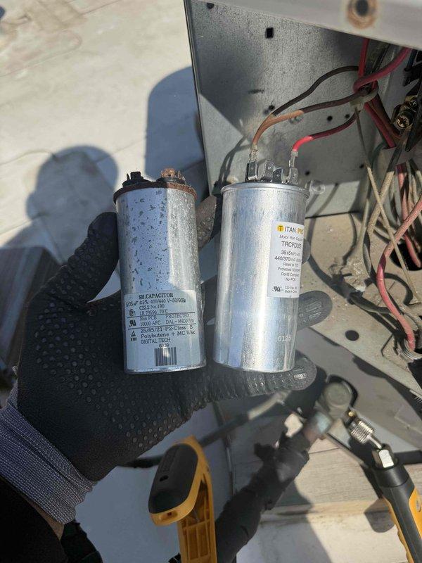 Responded to commercial HVAC service call and diagnosed failed capacitors affecting system operation. Removed two deteriorated capacitors from the unit, including one showing significant weathering, rust, and surface deterioration. Installed new TITAN PRO replacement capacitors rated at 440/370VAC per manufacturer specifications. Verified proper electrical connections at terminal blocks, ensured secure mounting, and tested system operation to confirm restoration of normal function.