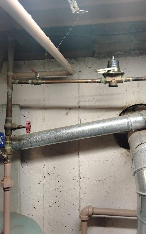 Responded to emergency water leak in mechanical room where radiator had been physically impacted, causing active water discharge. Upon arrival, assessed damage to heating system piping and immediately shut off water supply to affected radiator to stop leak. Inspected circulator pumps, pressure tank, and associated copper piping for additional damage or compromised connections. Coordinated with office to obtain property management approval for repairs per building protocols. Repaired damaged radiator connection point, replaced affected fittings, and restored water supply to system. Tested all connections for leaks, verified proper system pressure, and confirmed circulator pumps were operating correctly. Documented mechanical room conditions with photographs showing piping configuration, pump assembly, and repair location for records.