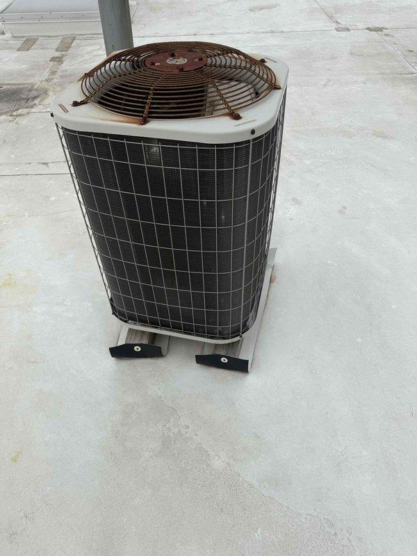 Completed spring preventive maintenance on commercial rooftop air conditioning unit. Performed comprehensive checklist inspection including visual assessment of condenser unit, fan assembly, and external components. Updated equipment information and filter specifications for maintenance records, documenting unit condition and operational status with photographic documentation of outdoor condenser unit showing cylindrical configuration with protective grille and fan assembly mounted on concrete pad.
