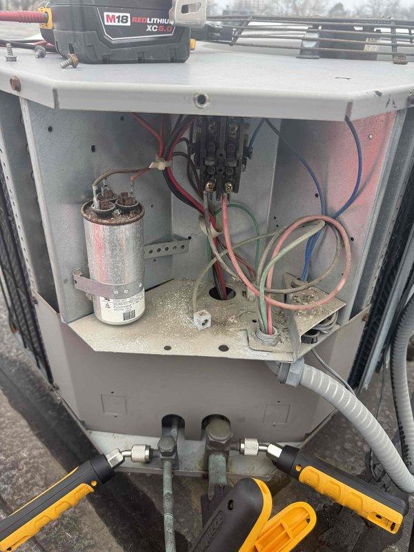 Completed spring preventive maintenance on commercial rooftop HVAC unit per contracted service agreement. Performed comprehensive inspection of electrical components, capacitor, refrigerant connections, and mechanical systems with access panel removed. Documented equipment conditions, verified operational parameters with gauges, cleaned interior compartment of accumulated debris, and captured updated equipment information and filter specifications for maintenance records.