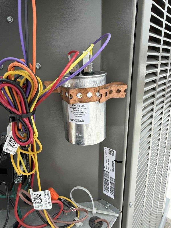 Responded to commercial rooftop HVAC unit requiring capacitor replacement. Upon inspection, diagnosed failed run capacitor preventing compressor operation. Removed defective capacitor and installed new TITAN PRO TRCFD455 replacement capacitor with proper electrical specifications. Verified all wire connections were secure, tested unit operation, and confirmed system returned to normal cooling function.