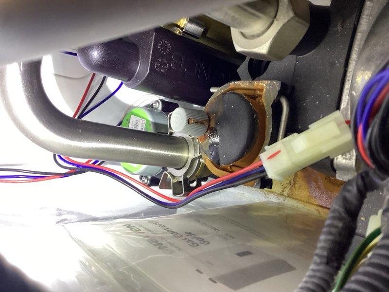 Replaced failed flame rod assembly on Navien tankless water heater. Unit was experiencing ignition issues due to corroded flame sensor, which was preventing proper burner operation. Installed new OEM flame rod assembly, tested system operation, and verified proper ignition sequence and flame detection functionality.