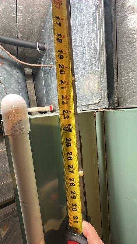 Conducted commercial HVAC assessment for air conditioning system experiencing inadequate cooling to upper floor areas. Accessed rooftop equipment using extension ladder to third-floor level and performed comprehensive evaluation of existing AC unit and ductwork configuration. Documented equipment dimensions, measured supply plenum and distribution components, and photographed internal cabinet assembly including blower section and energy specifications to provide accurate replacement or modification estimate for multi-unit commercial facility.