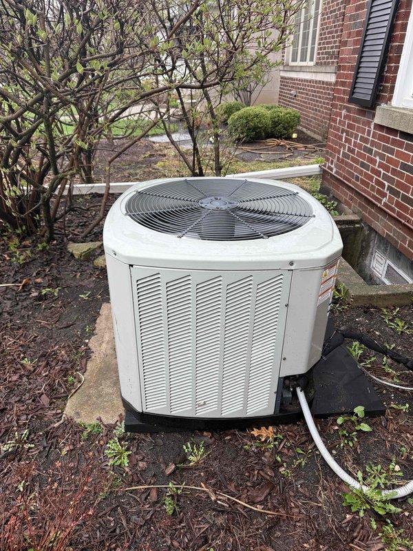 Completed spring clean and check on residential air conditioning system per comfort plan maintenance agreement. Performed comprehensive inspection of outdoor condensing unit, cleaned evaporator coil showing moderate dust and debris accumulation between fins, verified refrigerant line connections, and confirmed proper unit operation. Reminded customer of pending estimate for attic fan replacement, with original unit currently stored at shop.