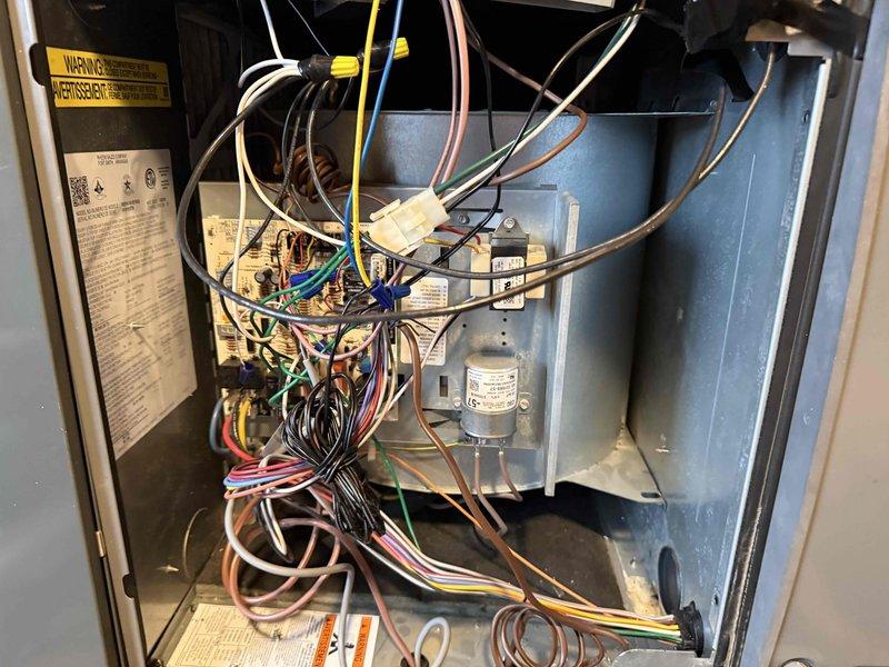 Performed comprehensive clean and check maintenance on residential air conditioning system and air scrubber unit per comfort plan agreement. Inspected all electrical connections, wiring harnesses, and control components within the air handler compartment, verifying proper wire terminations and secure connections throughout. Examined blower assembly, capacitor, and associated mechanical components for proper operation. Addressed concern regarding air scrubber indicator light status and verified system functionality. All safety labels and manufacturer specifications were reviewed, and unit was found to be operating within normal parameters upon completion of maintenance service.