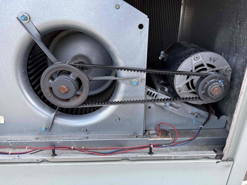 Completed belt replacement on rooftop unit #3. Removed worn 4L Type V belt from blower motor pulley system and installed new belt, ensuring proper tension and alignment between motor and blower assemblies. Unit tested and operating normally upon completion.