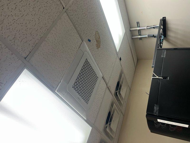 Installed PVC union on condensate and humidifier drain lines to create accessible service point for future maintenance and cleaning. Work completed on commercial HVAC system with rooftop condenser unit and interior ceiling-mounted air handler. Installation allows for proper drain line maintenance and prevents potential water backup issues.