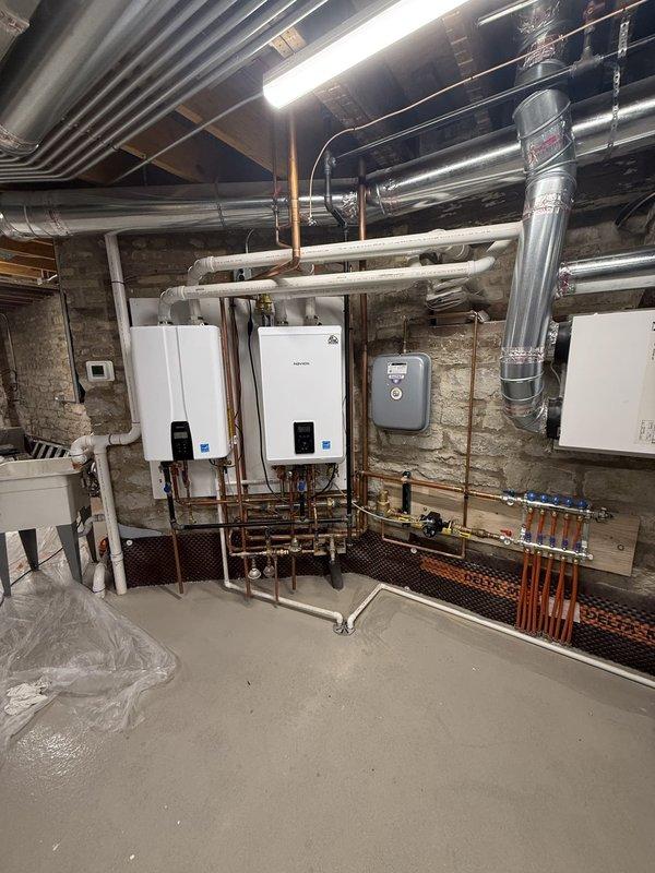 Continued troubleshooting thermostat connectivity issues in commercial mechanical room. Assessed Amana thermostat displaying 66 degrees in cooling mode and verified proper communication with HVAC system. Documented equipment installation including tankless water heaters, ductwork, and control systems to identify potential interference sources affecting thermostat network connectivity.