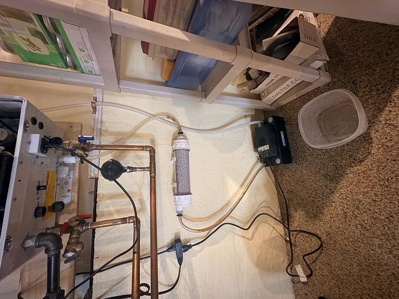 Responded to service call for leaking Navien tankless water heater unit. Upon inspection, identified active leak from heat exchanger assembly. Performed comprehensive system evaluation including examination of all plumbing connections, heat exchanger condition, and associated components. Inspected water filtration system and inlet connections for potential contributing factors. Tightened connections, verified proper operation of condensate drainage, and tested all supply and return lines. System restored to proper working condition with no active leaks detected upon completion of repairs.