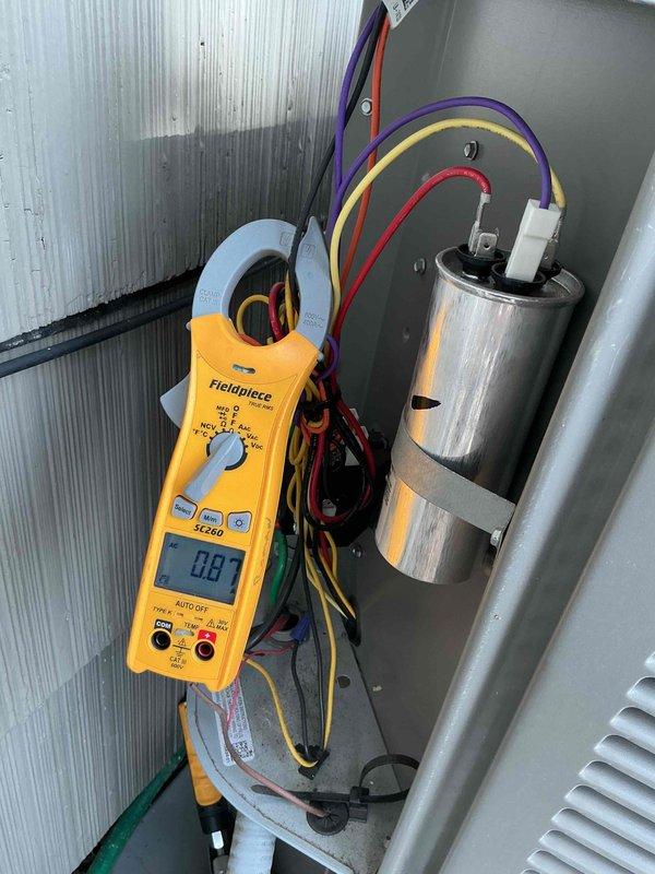 Completed spring preventative maintenance on residential air conditioning system per comfort plan agreement. Performed comprehensive clean and check procedures on outdoor condensing unit, including visual inspection of cabinet condition, verification of proper airflow through louvers and fan grille, and electrical diagnostics using clamp meter to measure amperage draw and capacitor performance. All components tested within normal operating parameters with amperage reading of 0.81 amps recorded at time of inspection.